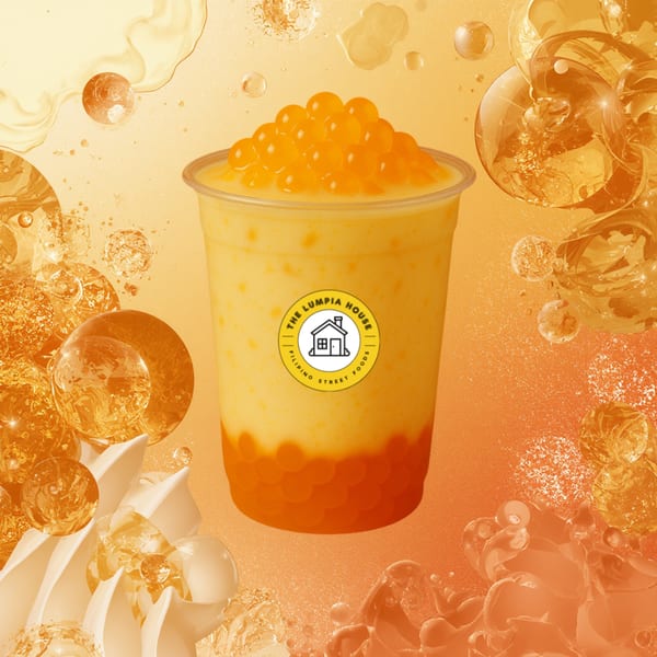 A mango-flavored drink with popping boba from The Lumpia House, set against an orange bubbly background.