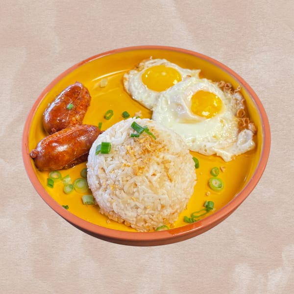 A yellow plate with two fried eggs, two sausages, and a mound of rice topped with green onions.